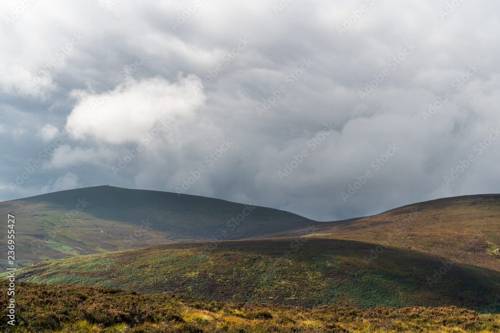Shapes of mountains under a moody sky. Irish landscape in Wicklow Mountains on an autumn day, before the storm. Shapes of mountains under a moody sky. Irish landscape in Wicklow Mountains on an autumn day, before the storm.