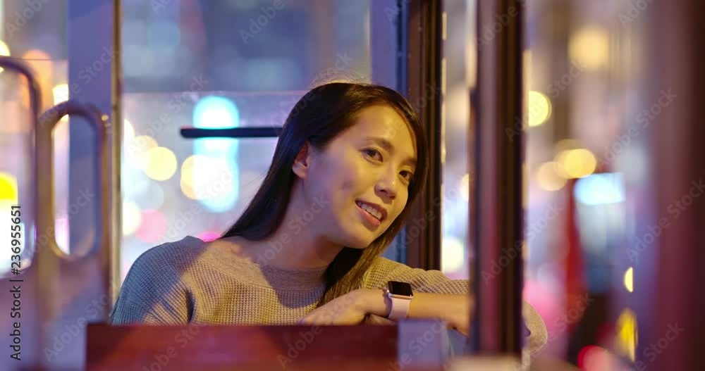 Woman take the tram in Hong Kong at night Woman take the tram in Hong Kong at night