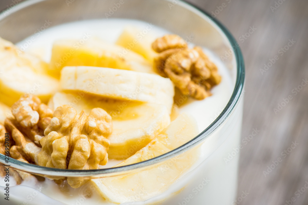 Healthy breakfast with banana and nuts. Selective focus.