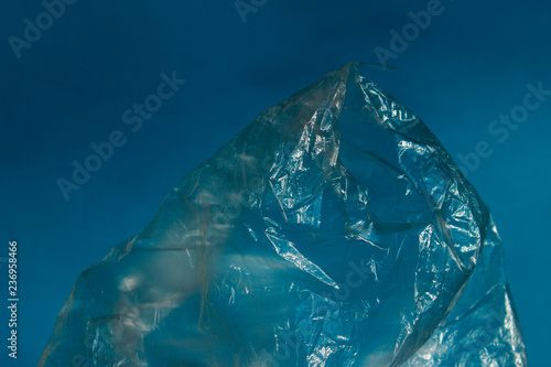 Abstract Background Textures. Cropped Shot Of Plastic Bag Over Blue Background.  Environmental Problems And Nature Pollution Concept.   