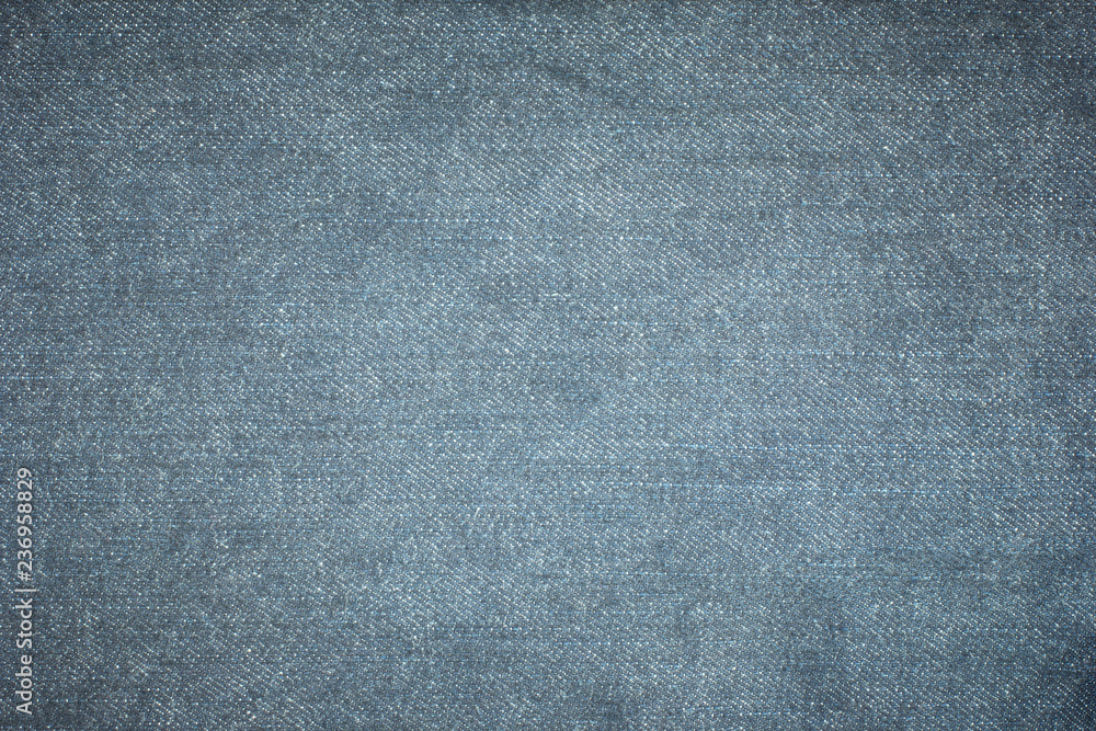 Old blue denim jeans texture or background with visible fibers Old blue denim jeans texture or background with visible fibers