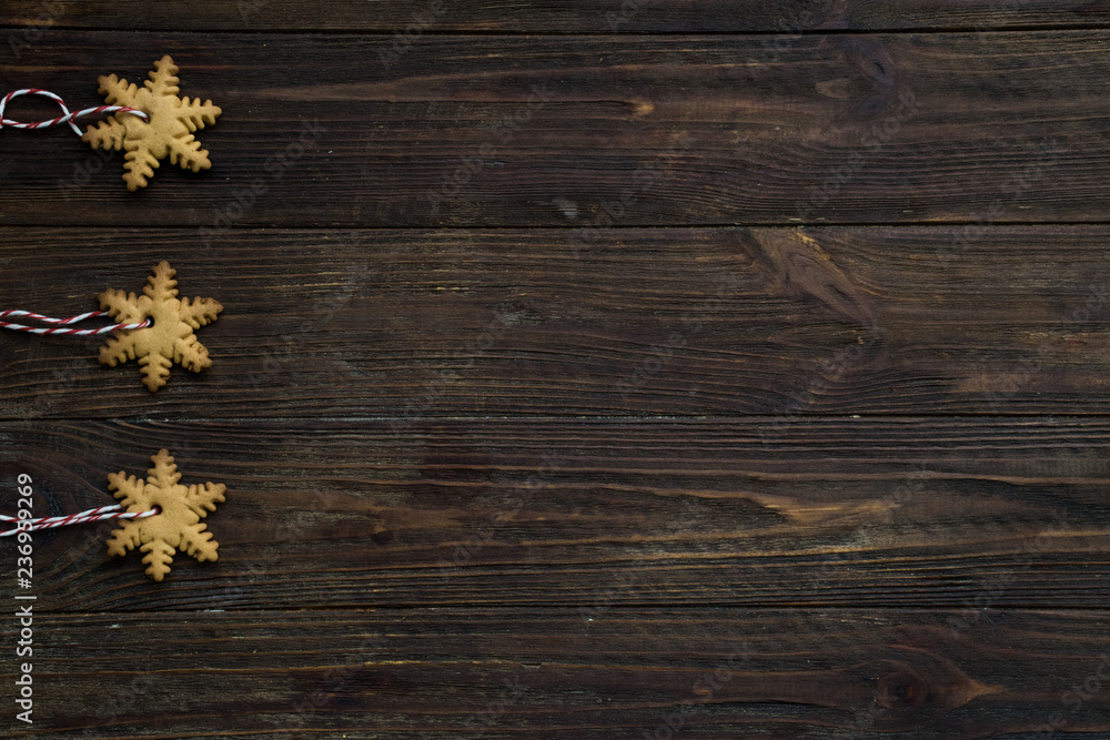 Hand made New Year's toys of cookies on a brown wooden background. Top view. Copy space Hand made New Year's toys of cookies on a brown wooden background. Top view. Copy space