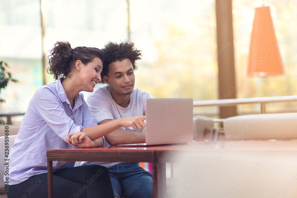 Interracial couple using tablet computer in coffee shop Interracial couple using tablet computer in coffee shop