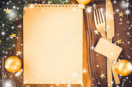 Christmas table place setting for dinner with notebook photo