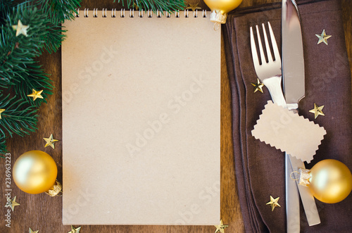 Christmas table place setting for dinner with notebook photo