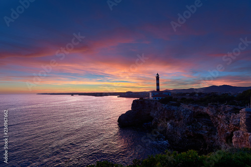 Lighthouse at sunset under a splendid sky of colors and a calm sea. Mediterranean sea in Spain. Baleares, Mallorca