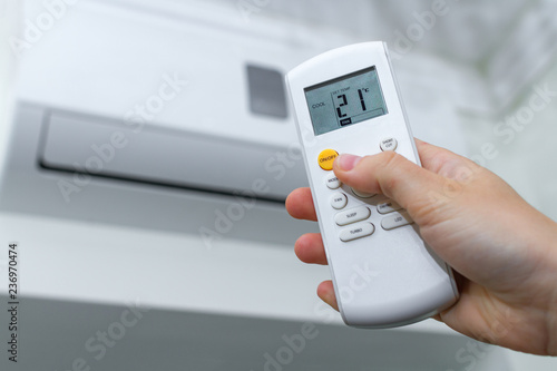 Air conditioner inside the room. Air conditioner with remote controller. Regulate the temperature in the room. Air cooling photo