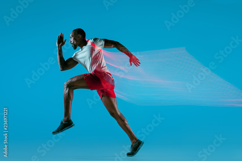 Full length portrait of active young muscular running man,