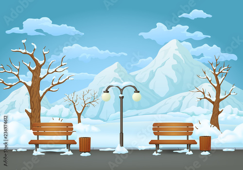 Winter day in the park, two benches with trash cans and street lamp on an asphalt trail with snow covered bare trees and bushes. Snowy mountain in the background.
