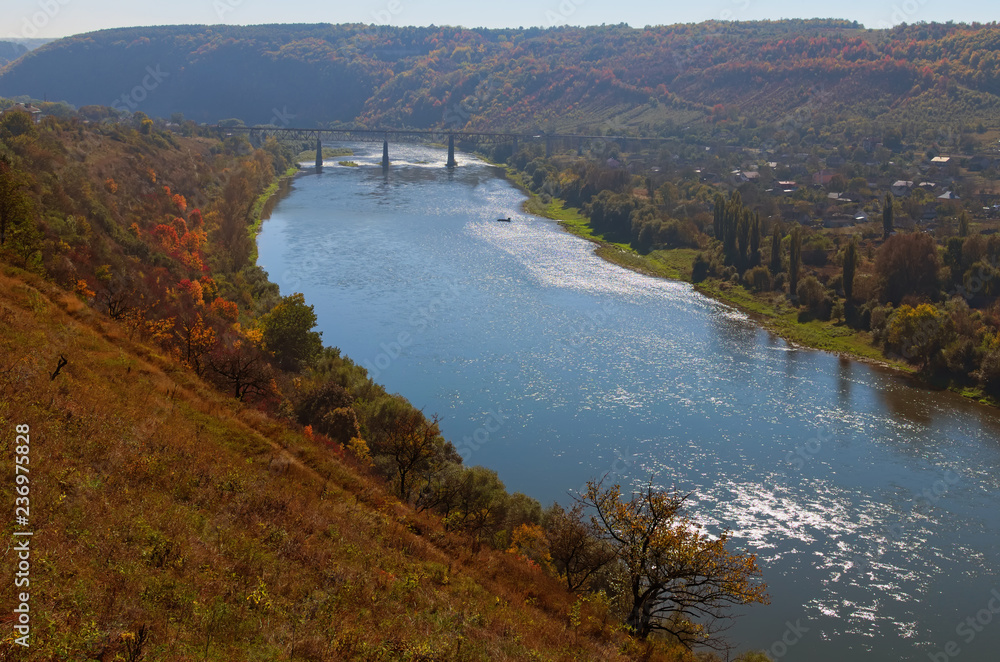 Railway bridge above Dnister River in the Zalishchyky town. Autumn landscape. Ternopil region, Ukraine