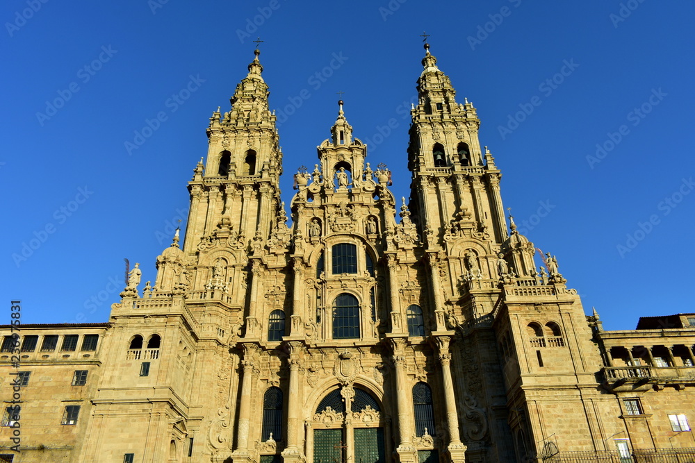 Cathedral with sunset light and clean stone. Plaza del Obradoiro, baroque facade and towers. Santiago de Compostela, Spain.