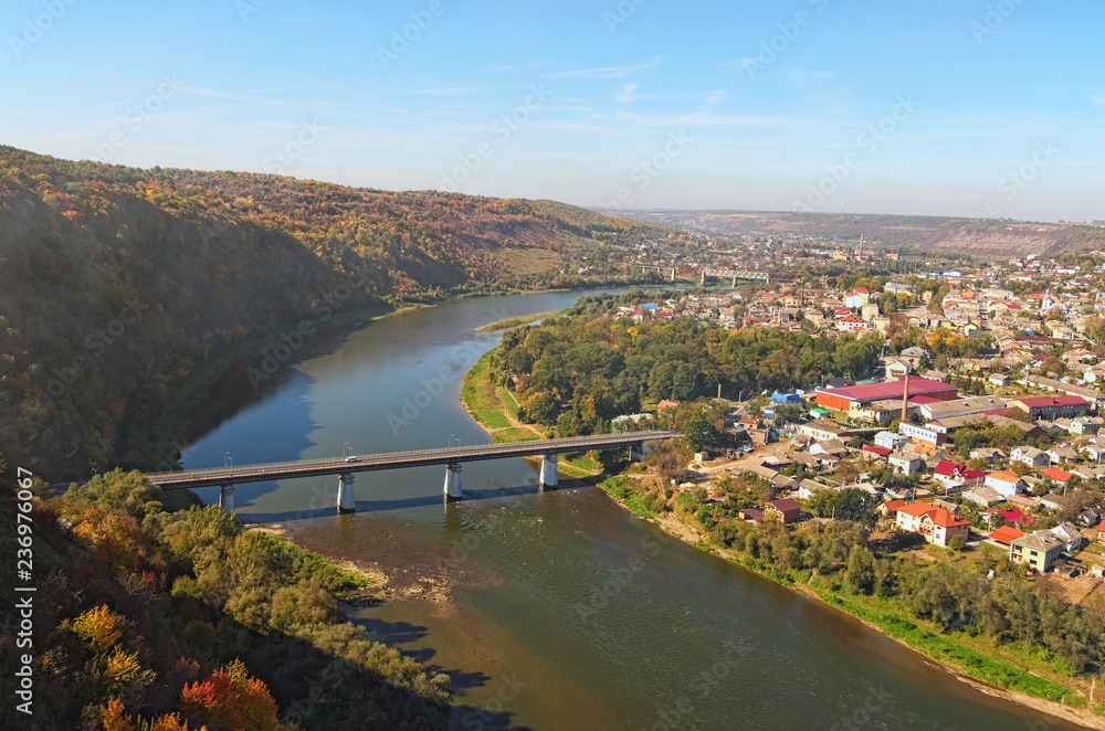 Fototapeta premium Wide angle landscape view of Zalishchyky town and canyon with Dnister River. Autumn landscape. Ternopil region, Ukraine