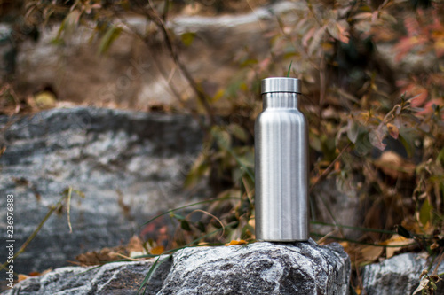 Insulated Stainless Bottle on the stone steps in the forest
