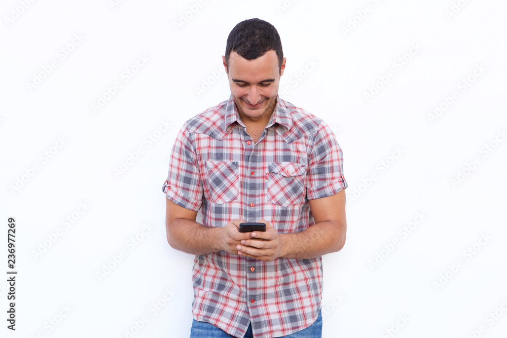 happy man looking at mobile phone by isolated white background happy man looking at mobile phone by isolated white background