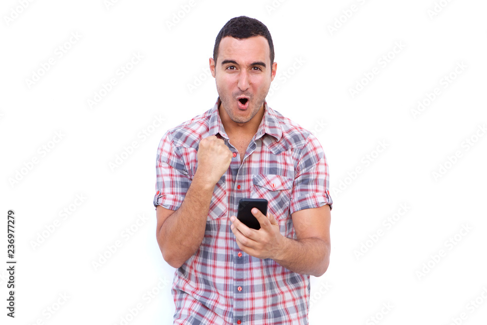 man with winning expression holding mobile phone against isolated white background man with winning expression holding mobile phone against isolated white background