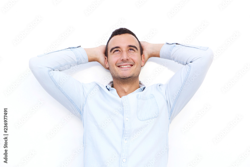 older guy smiling and looking up with hands behind head against shite background older guy smiling and looking up with hands behind head against shite background