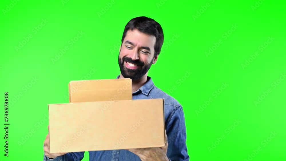 Man on green screen chroma key background holding boxes Man on green screen chroma key background holding boxes