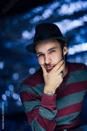 portrait of a guy in a hat on a blurred background