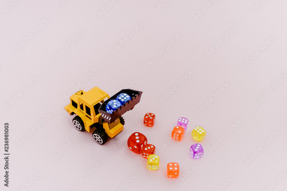 Obraz premium Colorful dices on light pink background, luck and gambling concept