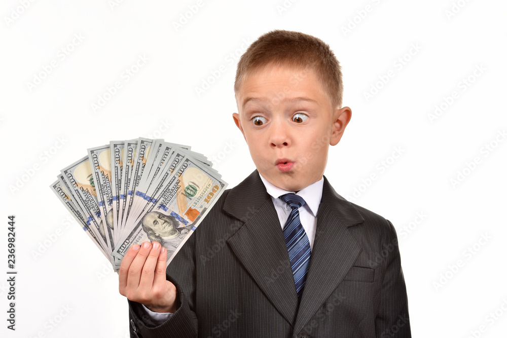 The boy holds dollars. Young businessman on a white background. The boy holds dollars. Young businessman on a white background.