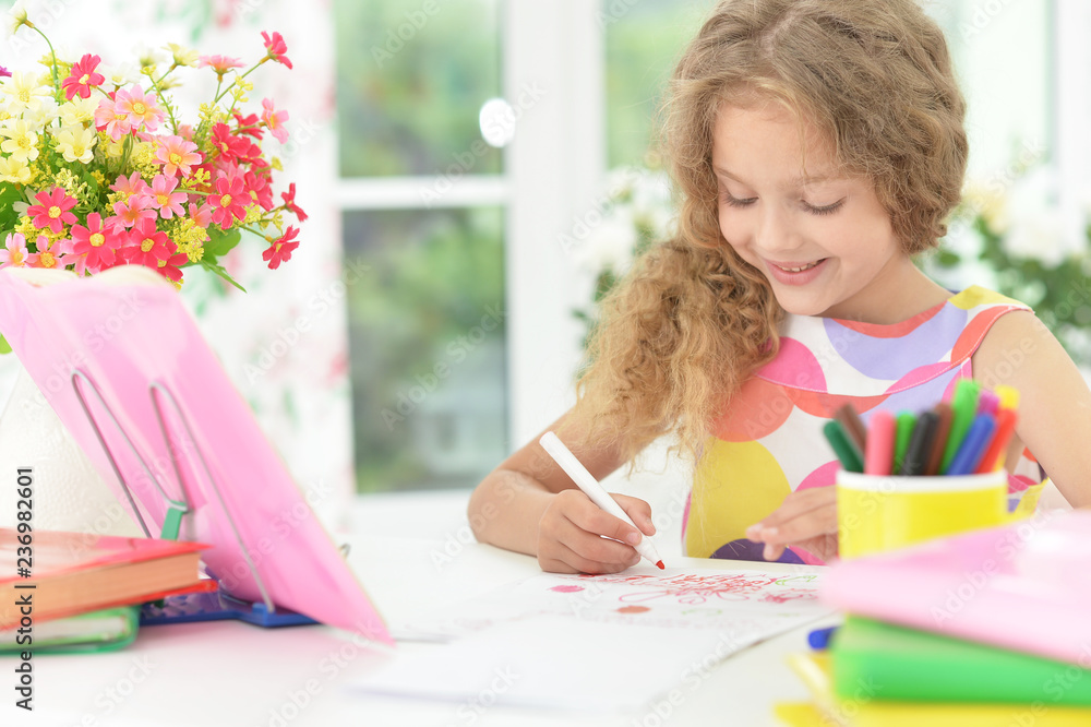 Portrait of cute schoolgirl doing homework in her room Portrait of cute schoolgirl doing homework in her room