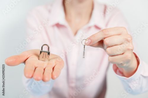 Padlock on the hand metal lock isolated on white background - Security Concept