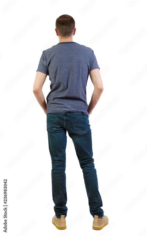 Back view of man in dark jeans. Standing young guy. Back view of man in dark jeans. Standing young guy.