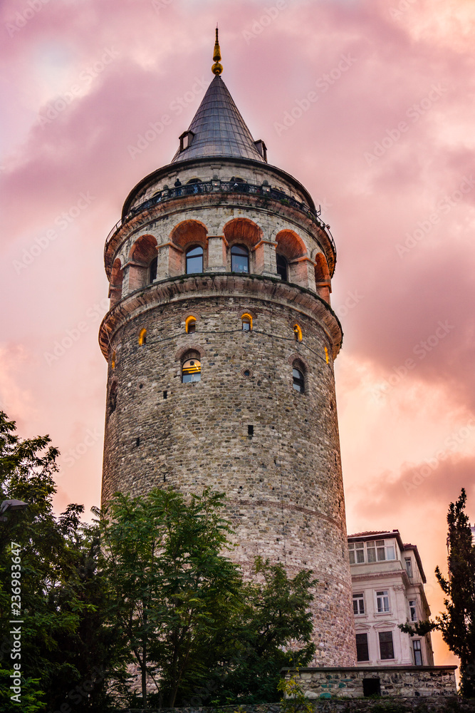 Galata Tower at purple night. Historical building or structure in Istanbul, Turkey. Beautiful view of old Galata Tower in twilight. One of the most famous and top rated tourist attraction in Istanbul.