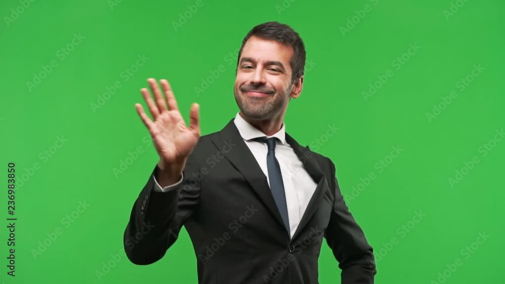 businessman saluting with hand with happy expression on green screen chroma key background businessman saluting with hand with happy expression on green screen chroma key background