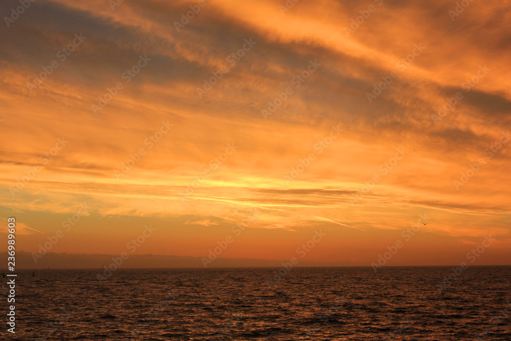 Sunset Sky Landscape Over Calm Sea Water with Vibrant Orange Cloudscape. Beautiful Sky Background at Sunset or Sunrise, Dusk and Dawn Panoramic Skyline View with Still Water on Summer Season Image