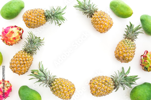 Frame pattern of pineapple  mango and dragon fruits on white background. Flat lay  top view. Food background.