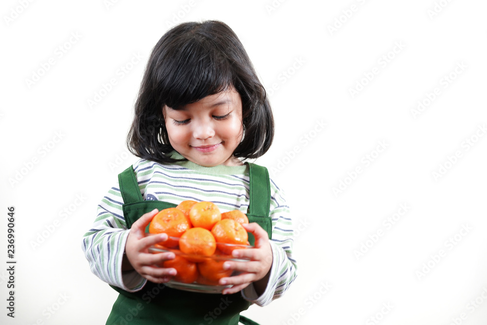 Asian kid with fresh orange. child girl with healthy fruit. Asian kid with fresh orange. child girl with healthy fruit.