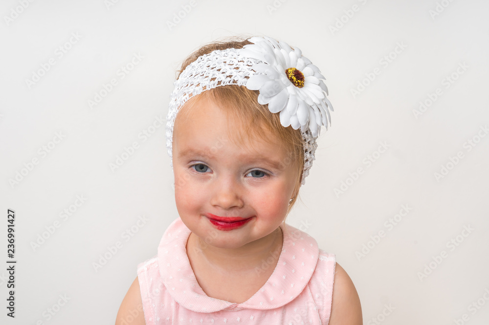 Cute little girl is applying makeup Cute little girl is applying makeup