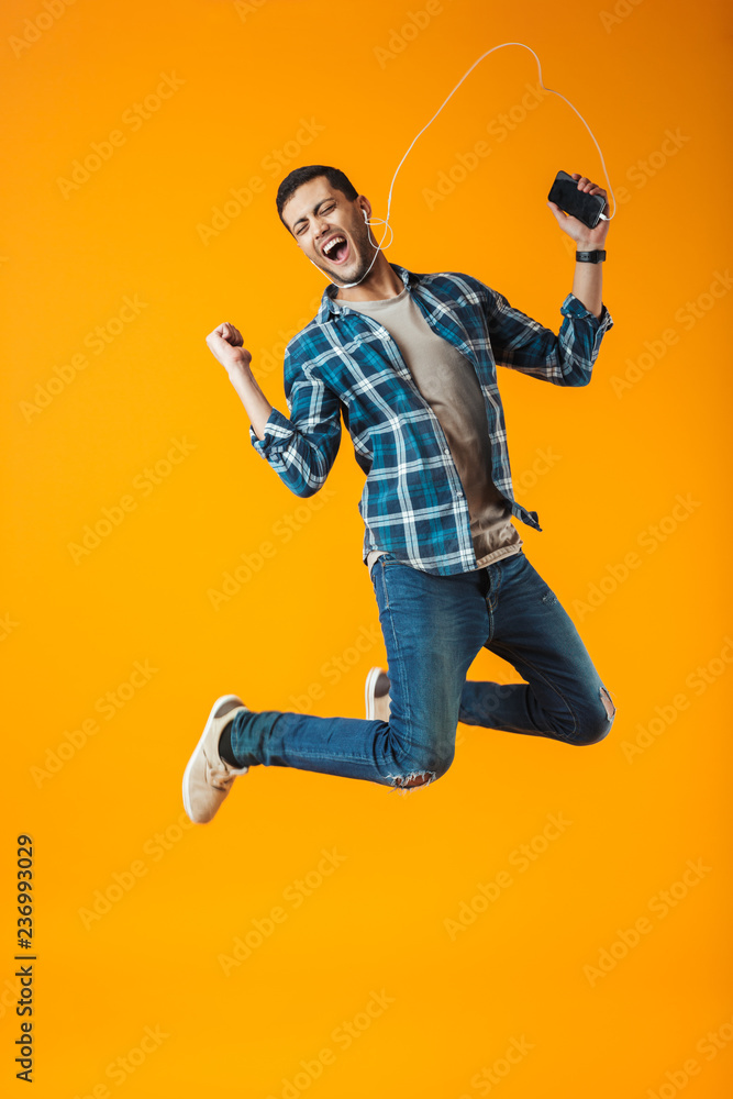Excited young man wearing plaid shirt