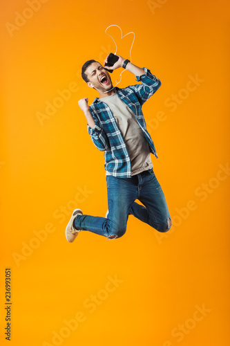 Excited young man wearing plaid shirt