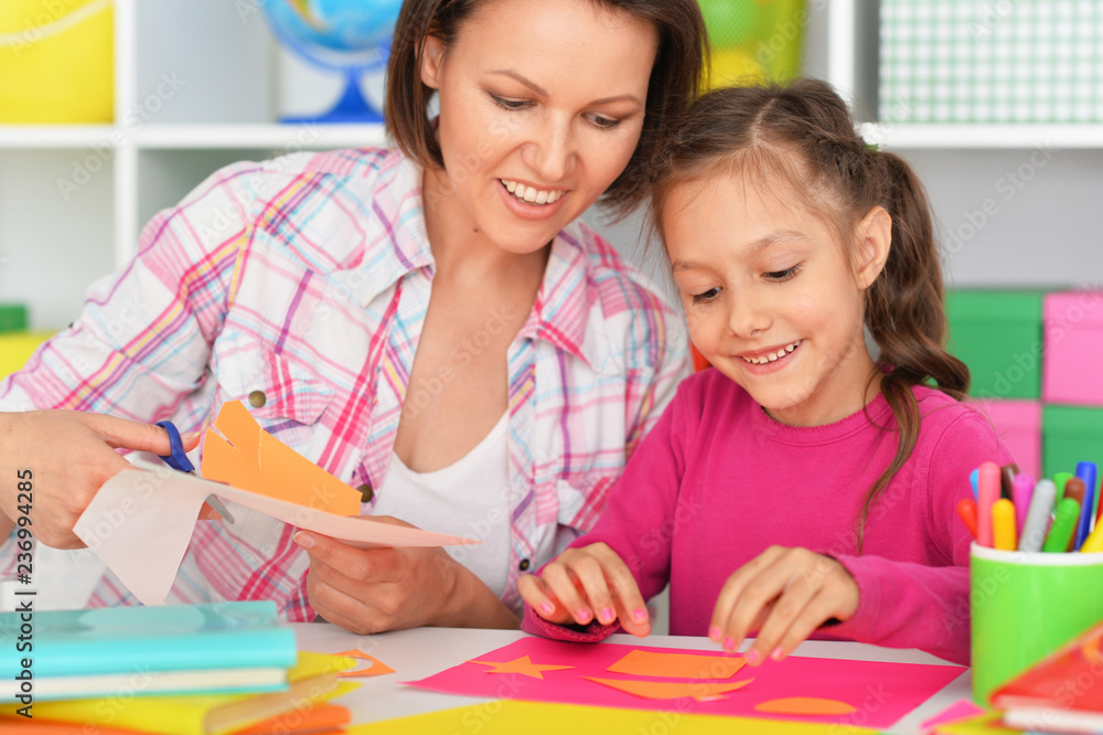 Portrait of mother and daughter gluing and cutting paper Portrait of mother and daughter gluing and cutting paper