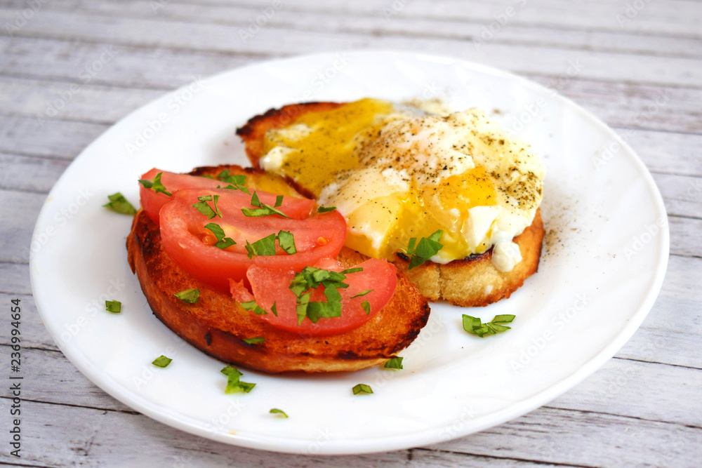 Crispy toast, scrambled eggs and tomatoes on a white plate for Breakfast. Crispy toast, scrambled eggs and tomatoes on a white plate for Breakfast.