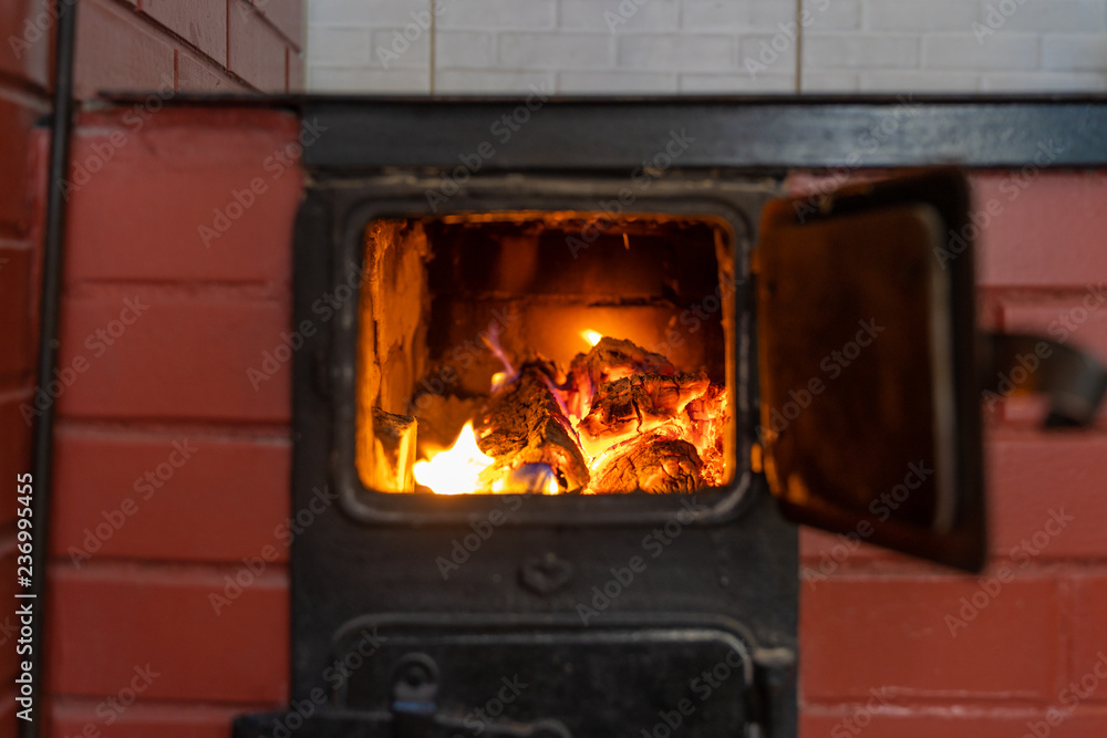 wood-burning stove with burning woods, bright fire