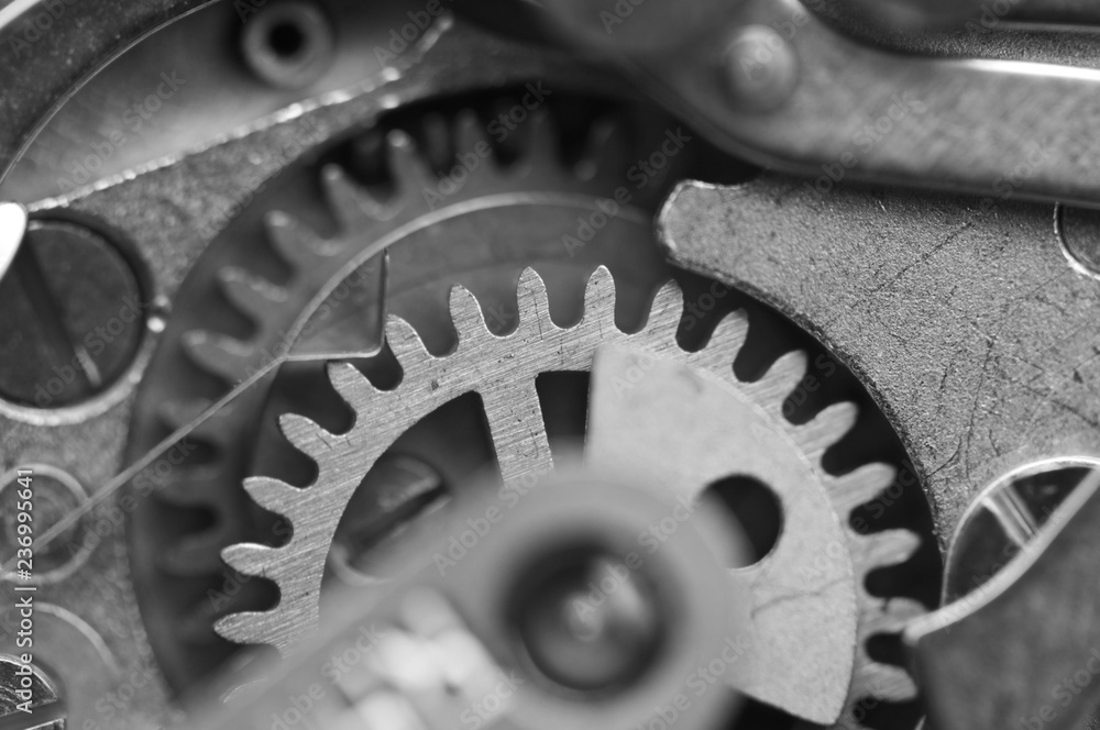  Black and white Background with metal cogwheels clockwork. Concept Teamwork. Macro