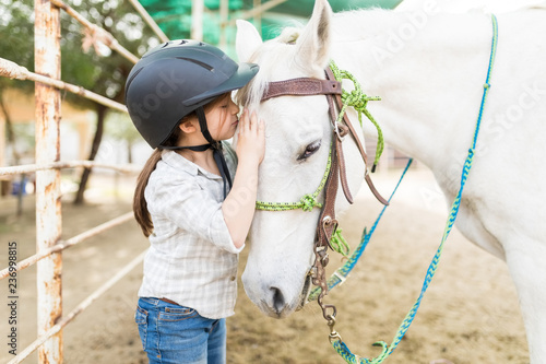 Obraz na plátne Affectionate Girl Kissing Horse