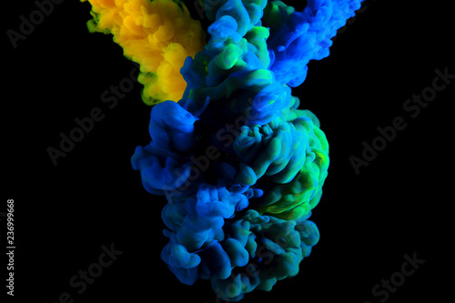 paint stream in water, interlacing of two colors forming a new hue in cloud in water , abstract background, multicolored dye on a black background
