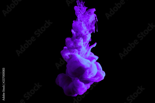 paint stream in water, colored cloud, abstract background, process of dilution purple dye on a black background