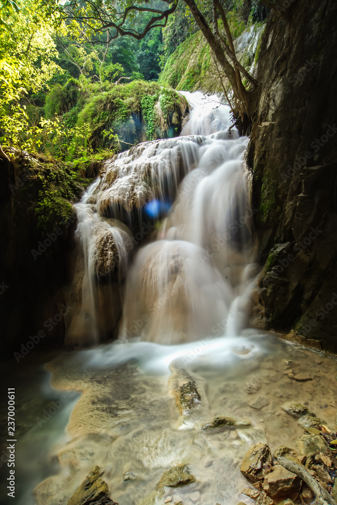 Beautiful nature rock waterfall steps in tropical rainforest at Kanchanaburi province, Thailand