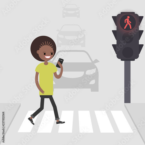 Young american african female character goes on a pedestrian crossing and looking into the phone.addicted to smartphone. Nomophobia. Flat vector illustration