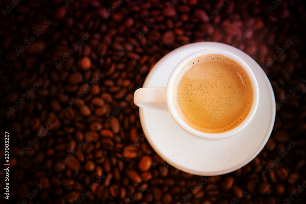 cup with freshly brewed coffee and whole coffee beans cup with freshly brewed coffee and whole coffee beans