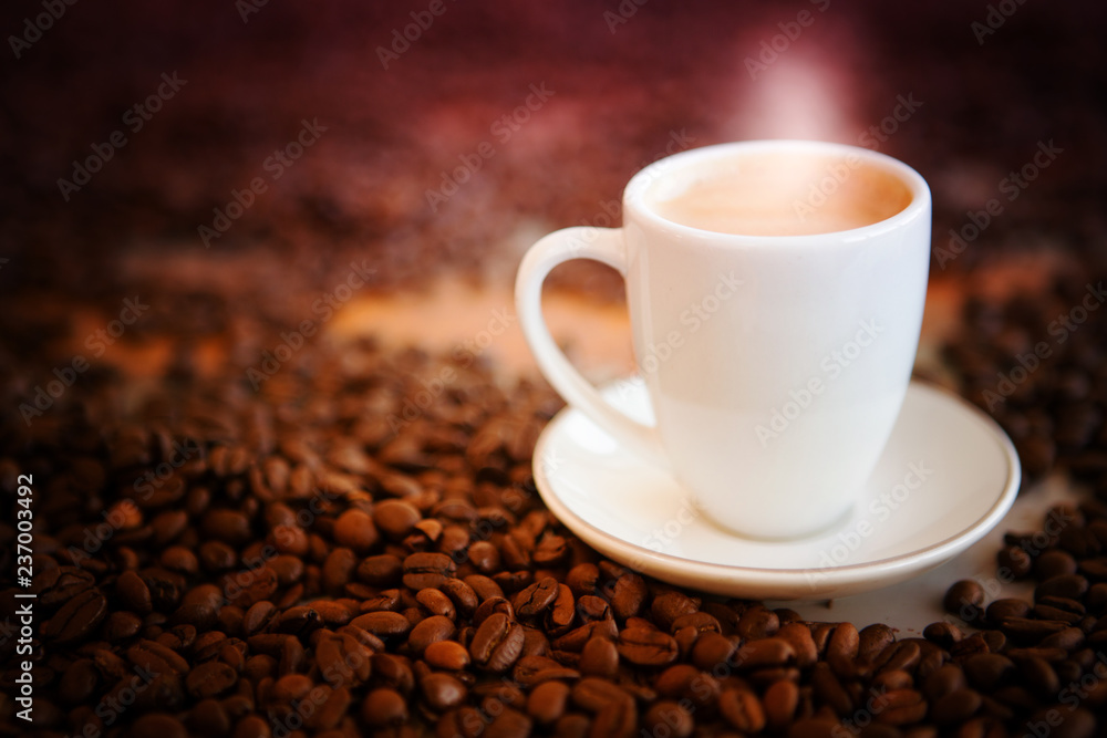 cup of fresh coffee on table with coffee beans cup of fresh coffee on table with coffee beans