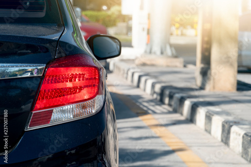Black Car on the road heading towards the goal of the trip. and break because traffic jam on the road. Body with dust.
