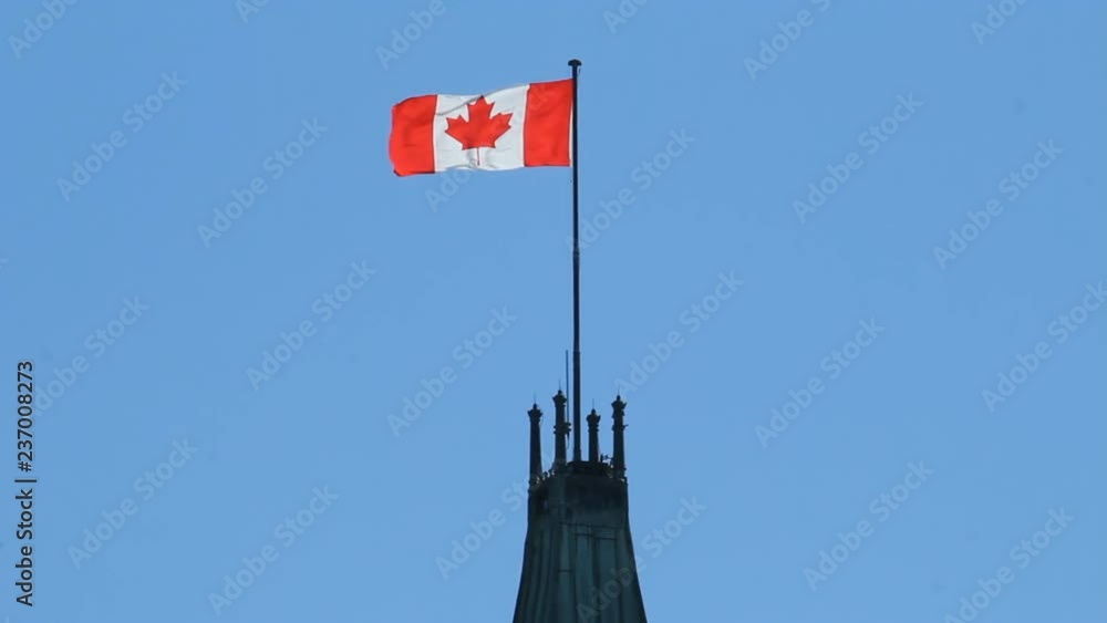 Canadian flag blowing on top of the Peace Tower, the highest point of