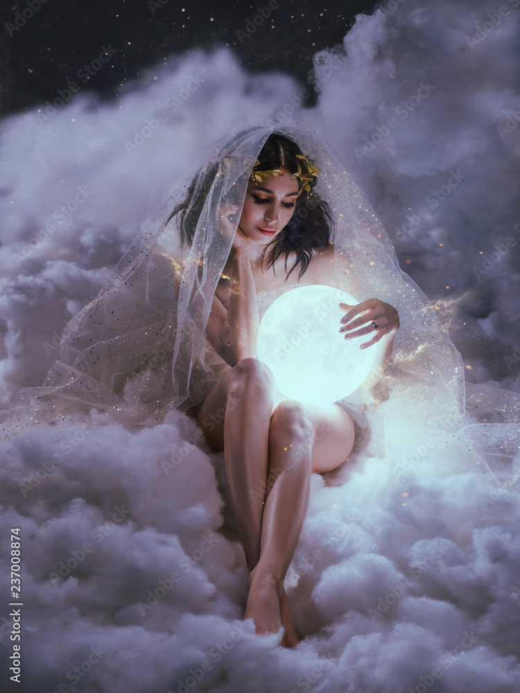 gorgeous slender sexy lady sits in the clouds and holds the moon in her  hands. daughter