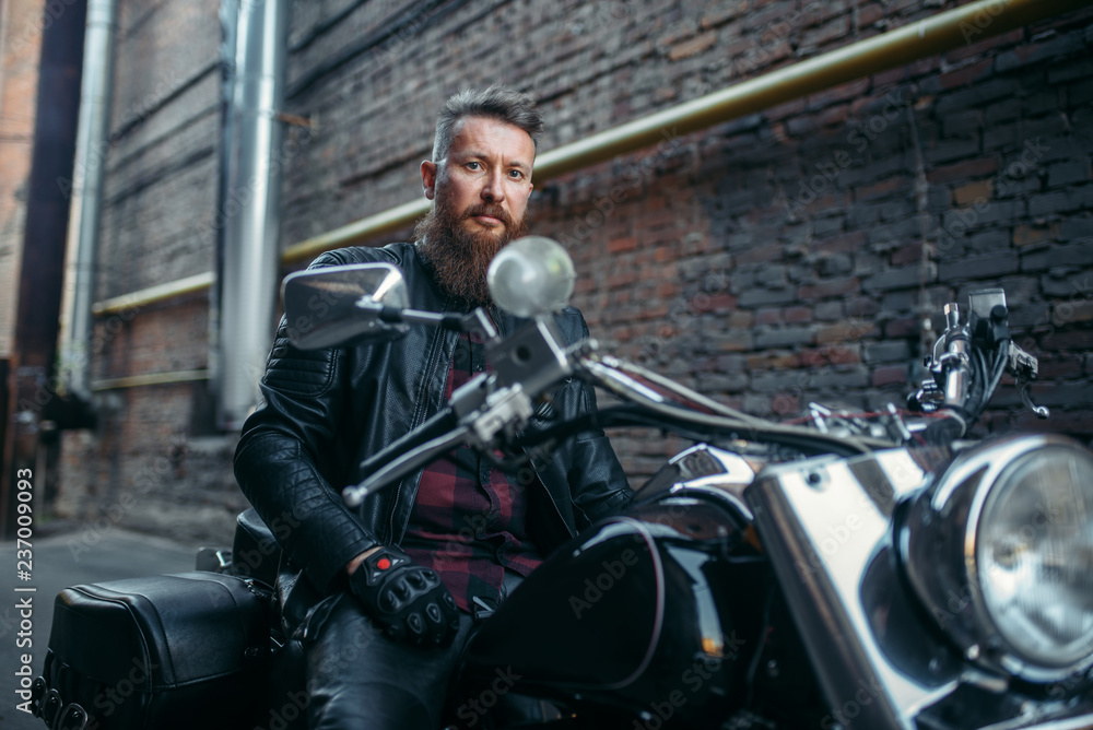 Biker in leather jacket on classical chopper Biker in leather jacket on classical chopper